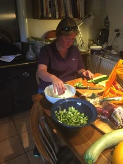 Liz making Greek salad in the kitchen